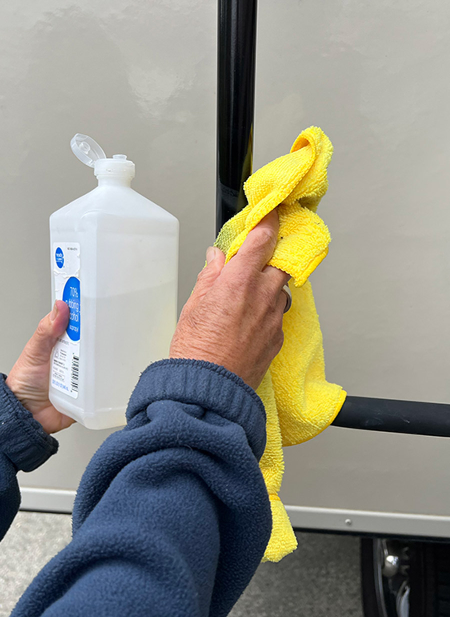cleaning a metal surface with a microfiber towel and rubbing alcohol