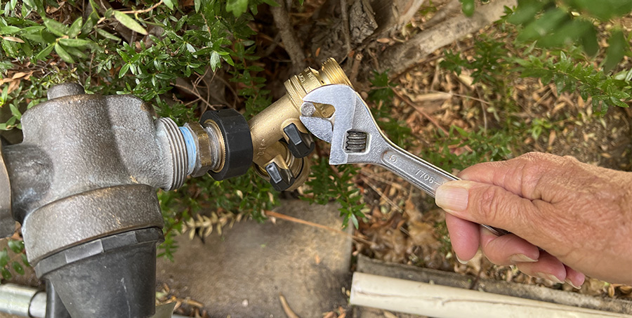 potable water faucet protected by back-flow converter