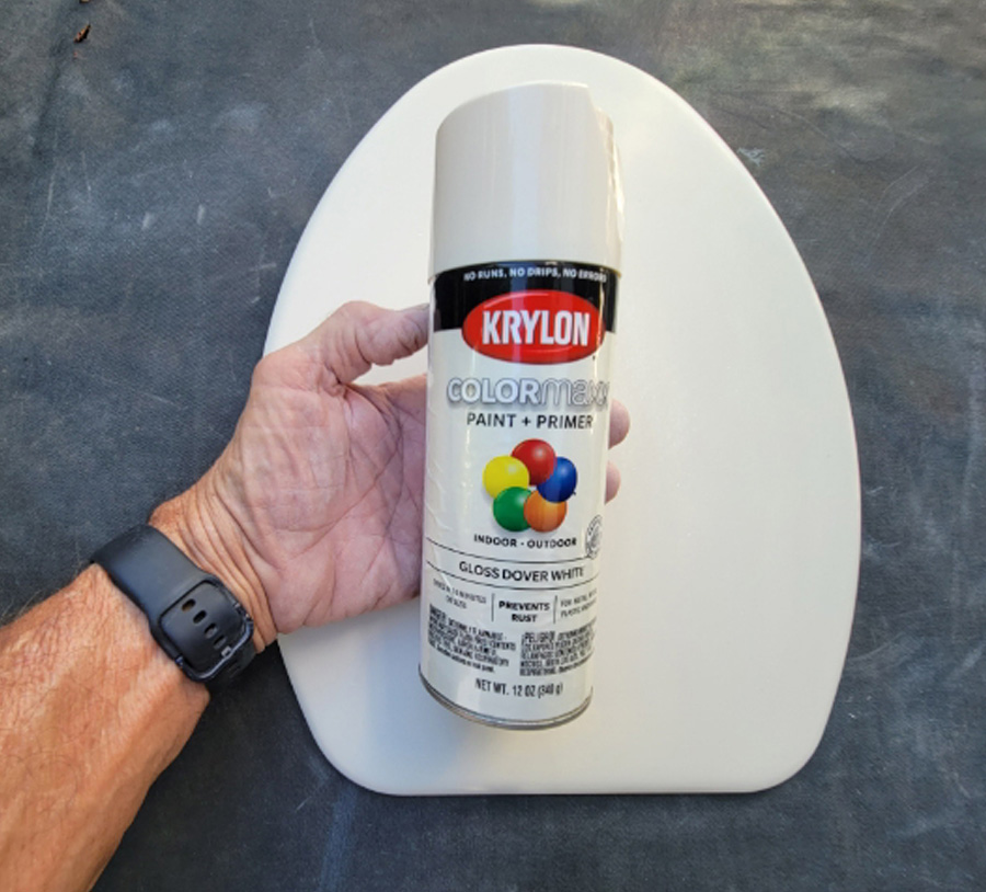 white spray paint can and a toilet seat cover
