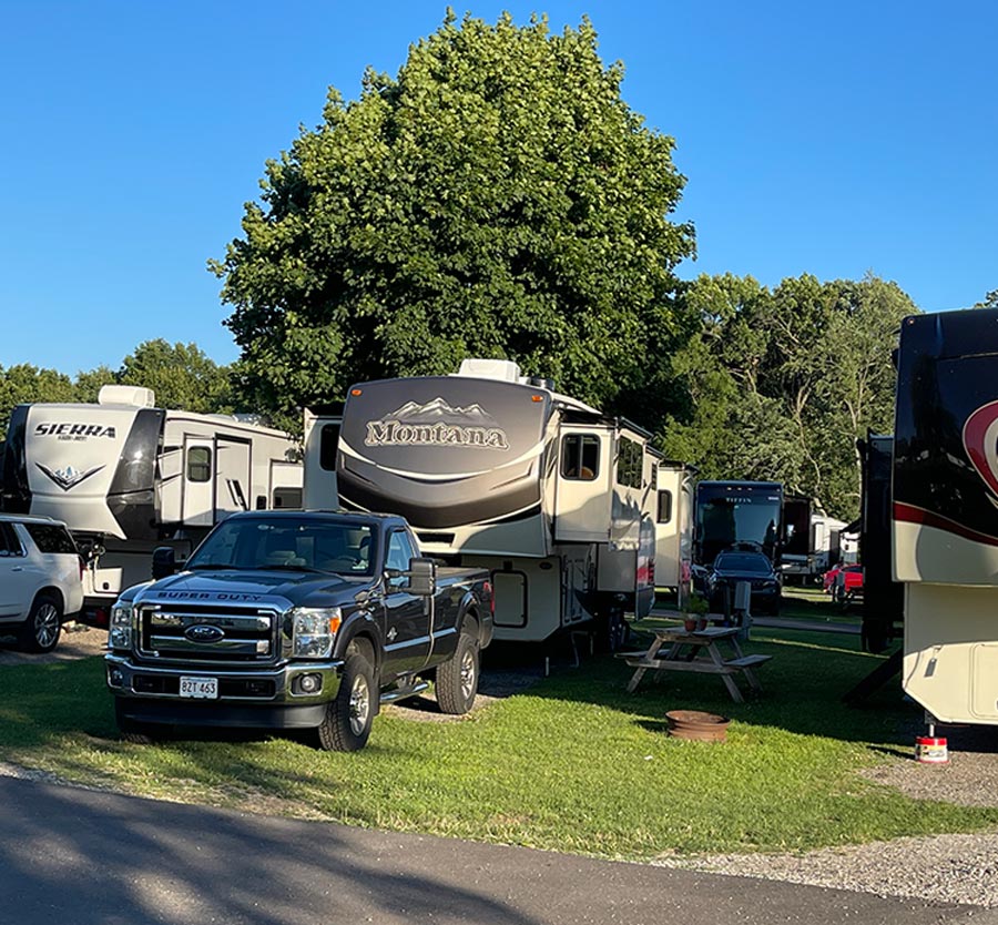 RV's and trailers parked in a grass field