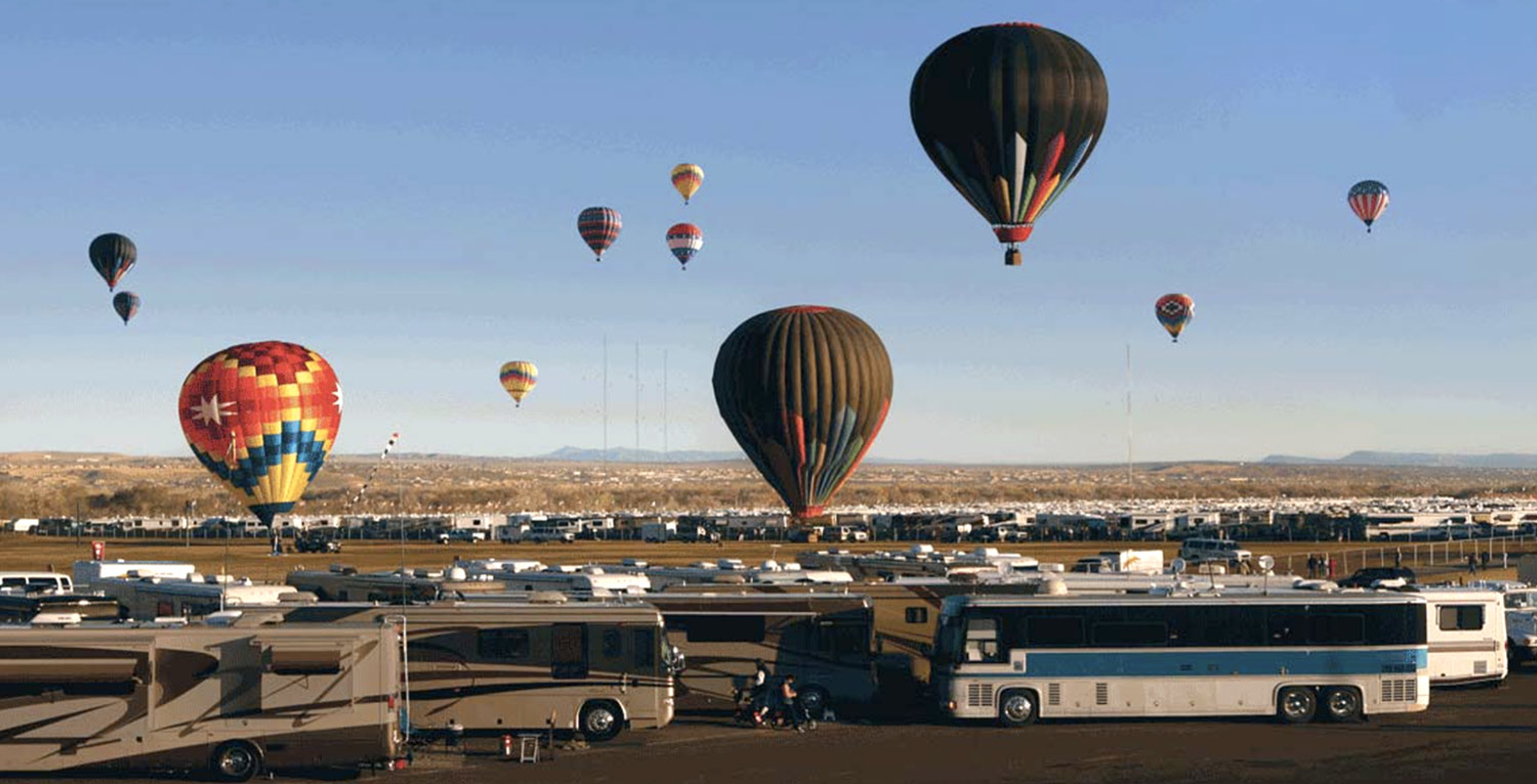 air balloons float at different heights over New Mexico’s Balloon Fiesta Park