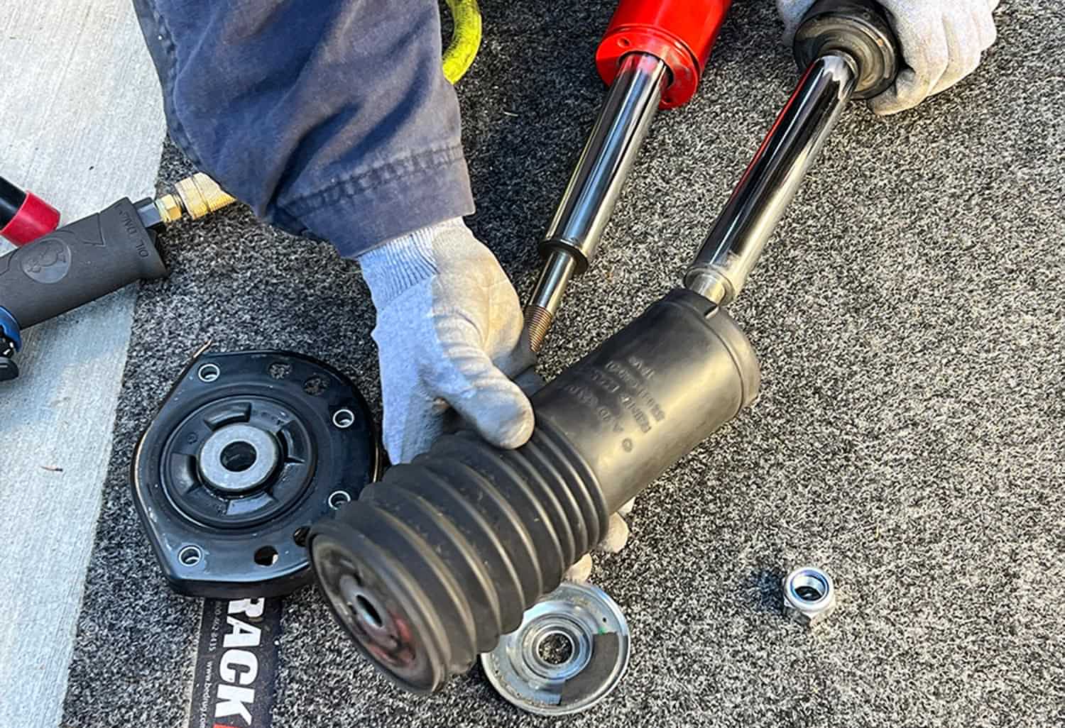 the top mounting plate, spacer and dust boot slide easily off the old strut