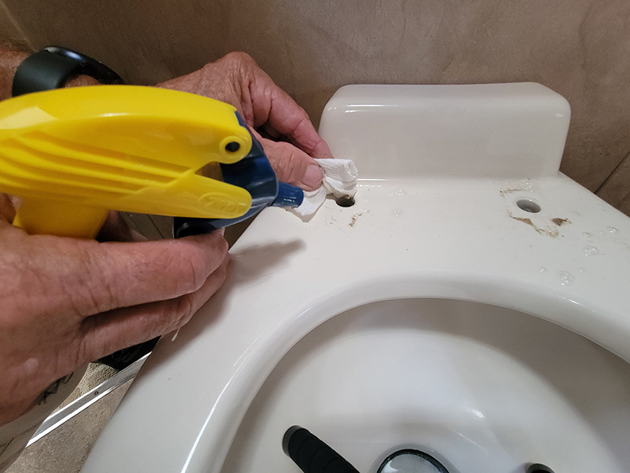 Someone Cleaning the toilet with a spray