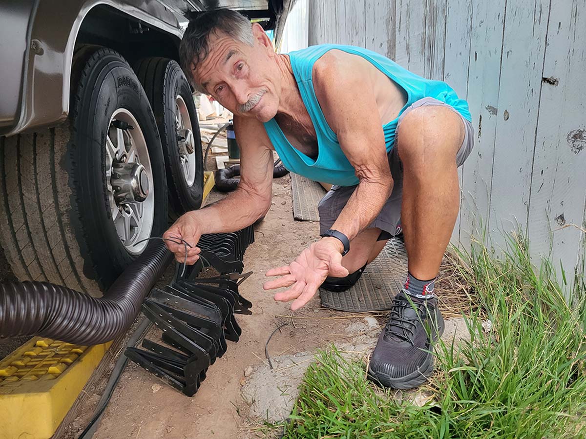 man installing sewer hose