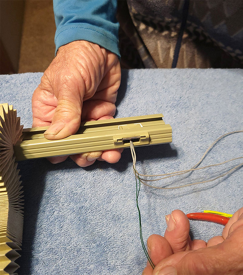 Pulling cords through latching mechanism