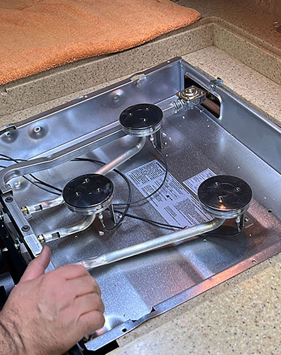 Once the gas line is checked, the Suburban three-burner slide-in cooktop was pushed into final position.