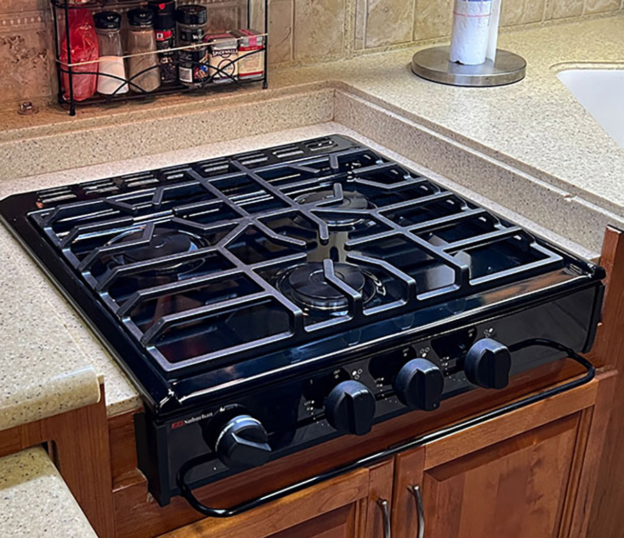 The final installation gives new life to an older RV galley. The Suburban slide-in cooktop is robust — and the style is modern.