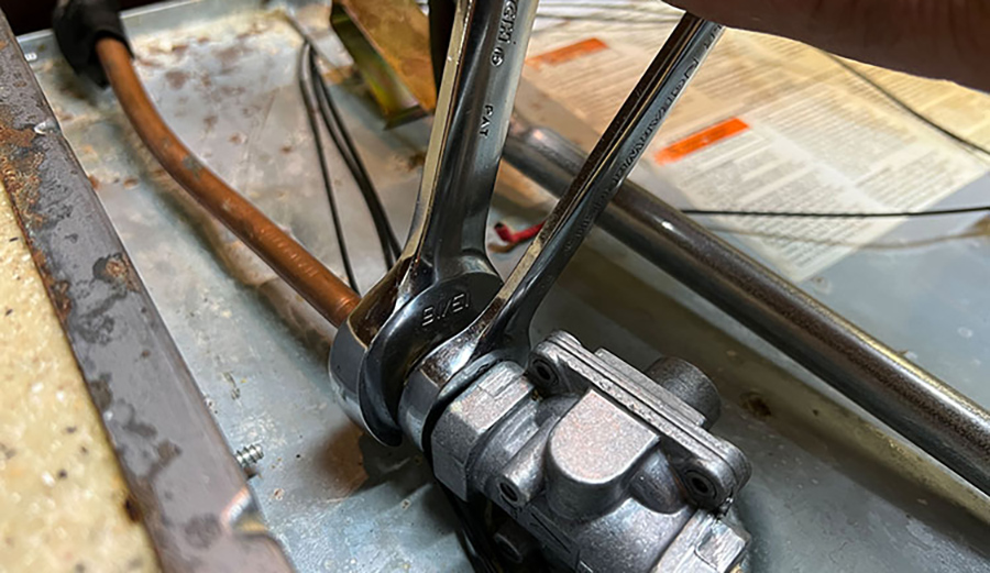 Two wrenches (13/16-inch & 5/8-inch) separate the gas feed line from the stove manifold. A ½-inch pipe plug is installed into the feed line to prevent any gas seepage as the rest of the install is done.
