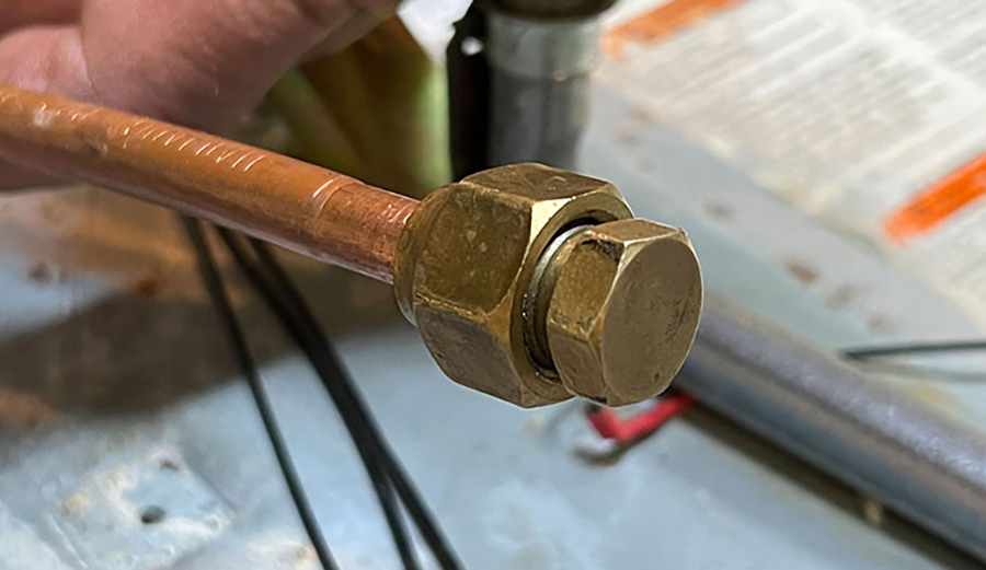 Two wrenches (13/16-inch & 5/8-inch) separate the gas feed line from the stove manifold. A ½-inch pipe plug is installed into the feed line to prevent any gas seepage as the rest of the install is done.