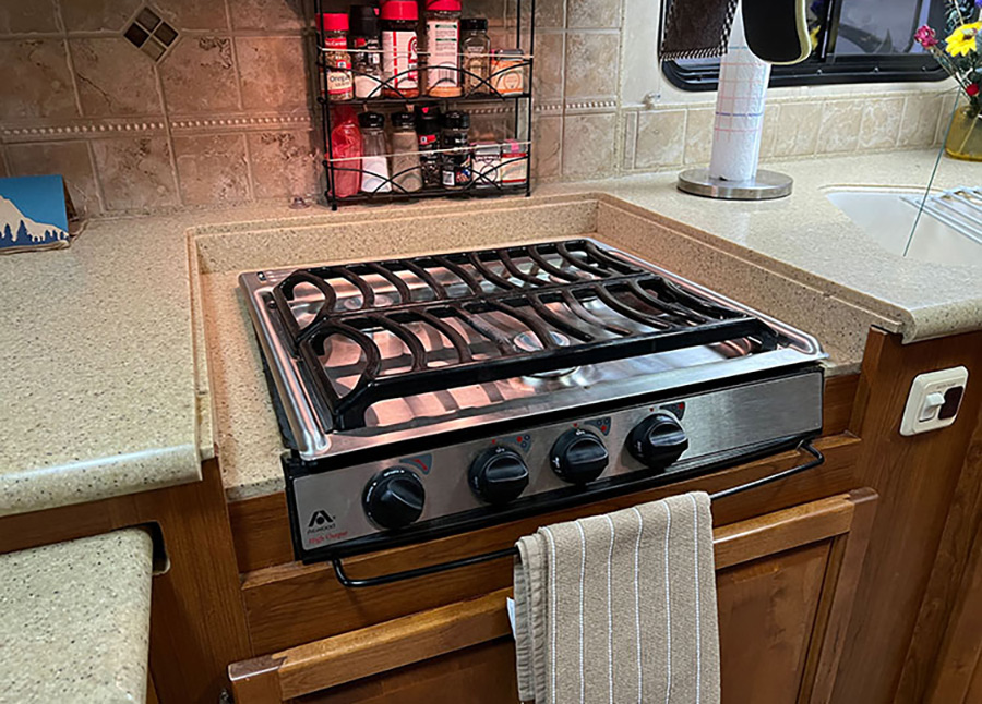 The owners of this 2008 Monaco Diplomat motorhome were tired of the old slide-in cooktop and wanted something nicer looking — and with sturdier grating and better burners.