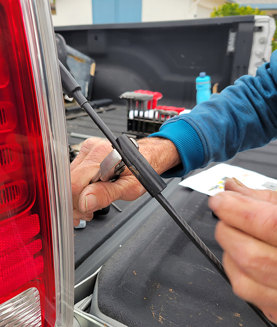 Measure 3 ½ inches from the upper end of the cable and mark the location for installing the cable clip provided in the kit. This clip provides rigidity to prevent the cable from getting tangled in the strut. After struggling to snap it over the cable (with pliers) a shot of WD-40 helped reduce friction — but it still needed a bit of persuasion.