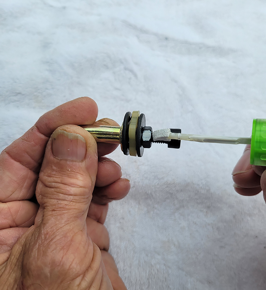 In order for the rivet nut to seat properly, the black nut must be turned at least nine rotations with a 10mm wrench (not supplied). Liquid White Out was used to mark the nut to count rotations. An extra two turns were needed to seat tightly, but the rivet nut was still a little cattywampus — but it worked.