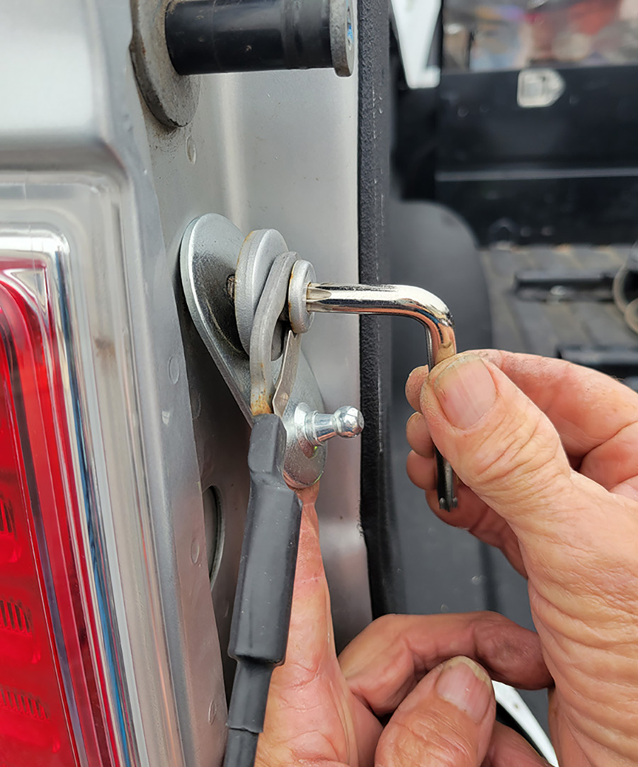 The upper mounting plate with the ball was attached to the bed with the existing bolt. The cable was attached at the time, but can also be removed and installed independently using the locking clip. While there were no torque specs for this bolt, it must be very tight.