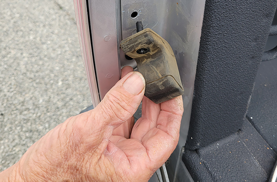 A diagonal cutter was used to cut a plastic rivet that held the rubber bumper in place. This bumper must be removed before the strut can be installed. It twisted off once the rivet was cut.