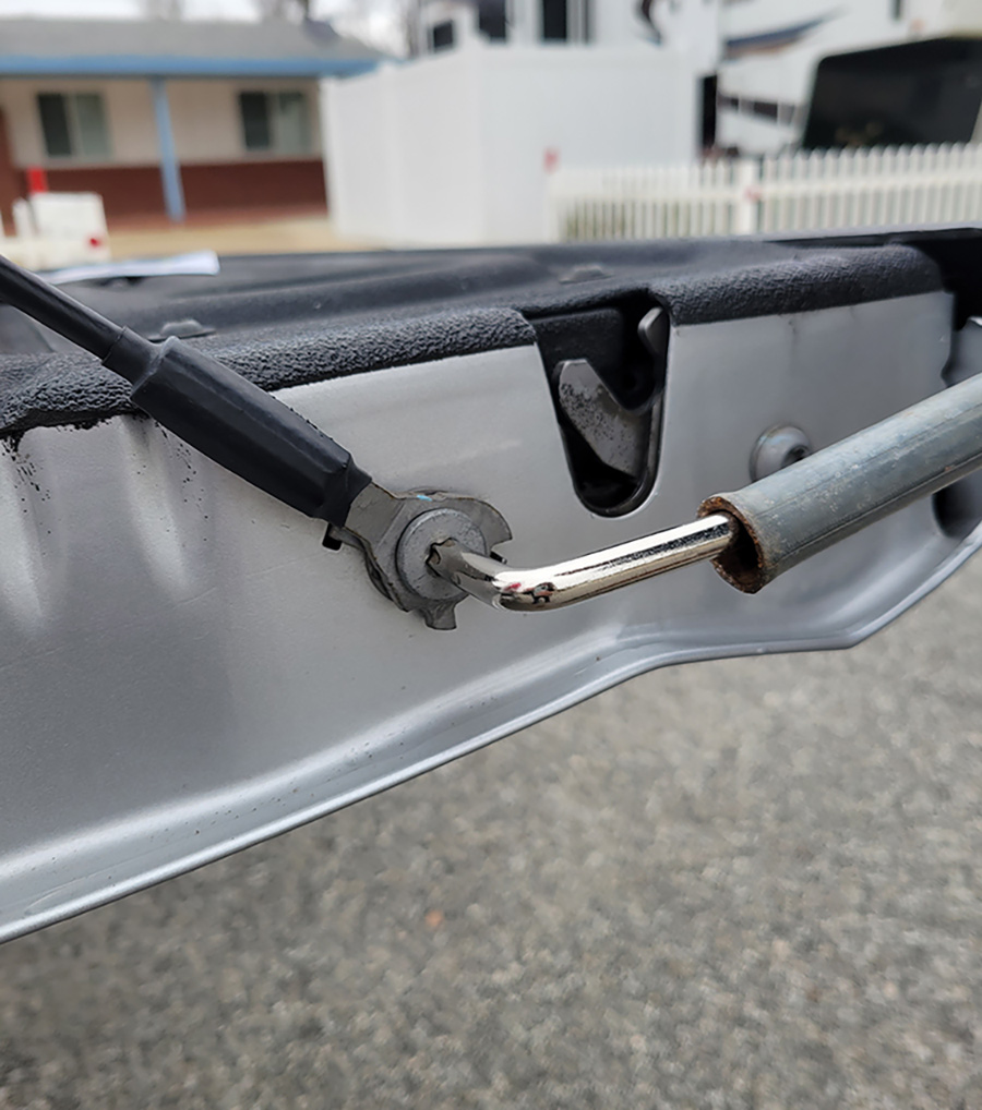 The bolt that secures the lower cable eyelet (to control the amount of tailgate travel) was removed to access the limiter plate to straighten the tabs. At first, a pliers was used to bend the tabs, but it didn’t work. Consequently, a punch and hammer (suggested in the instructions) made short work out of flattening the tabs. The limiter cannot be removed from the locking washer, so maneuvering the punch is a little tricky. Once flattened the limiter and cable end were replaced in the original position.
