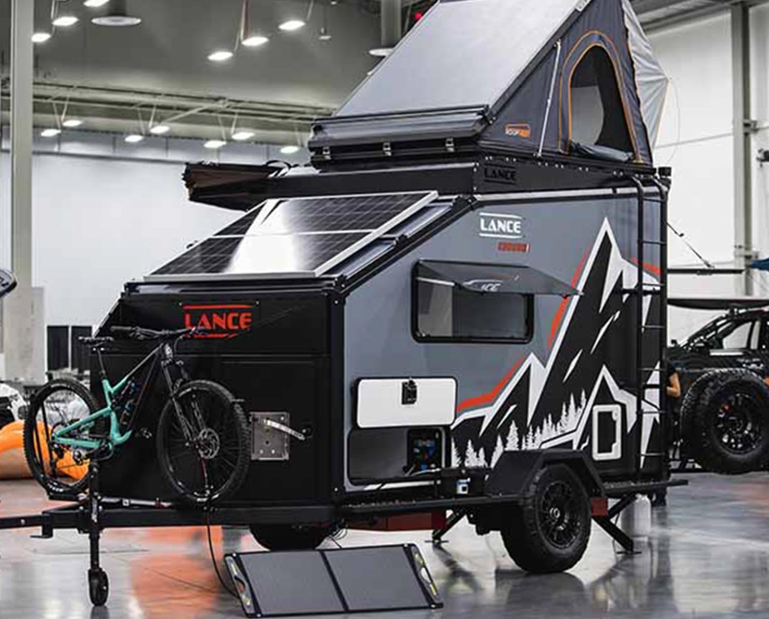 three quarter view of a Lance trailer on display in a facility