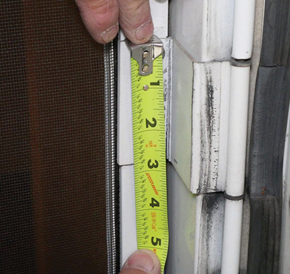 hinge being measured with measuring tape