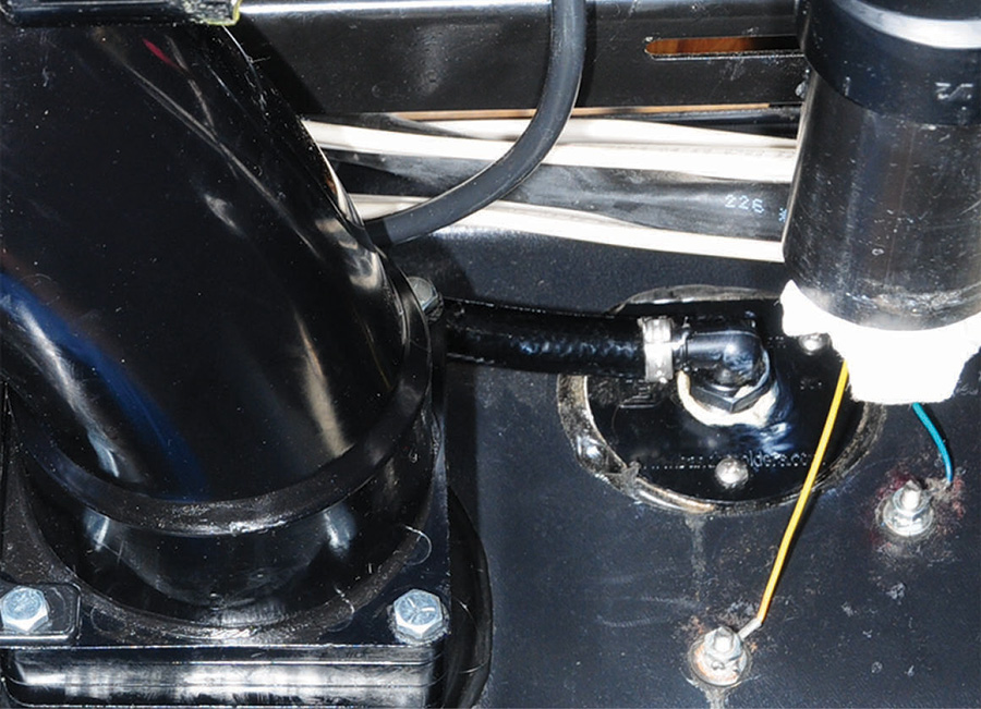 factory-installed elbow fitting in the black holding tank