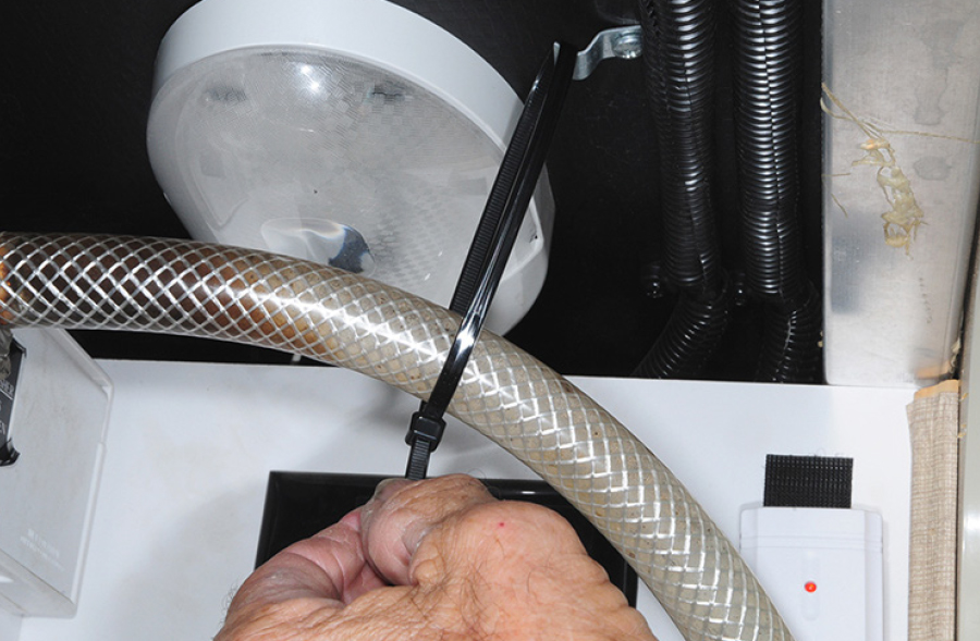 cable tie being installed to provide an element of strain relief for the hose connected to the city water fill