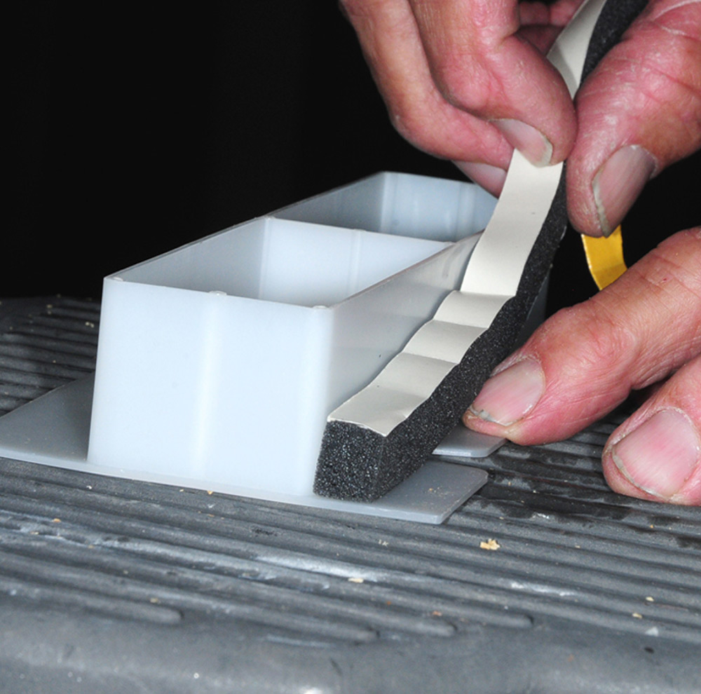 Applying adhesive foam tape around duct insert flange
