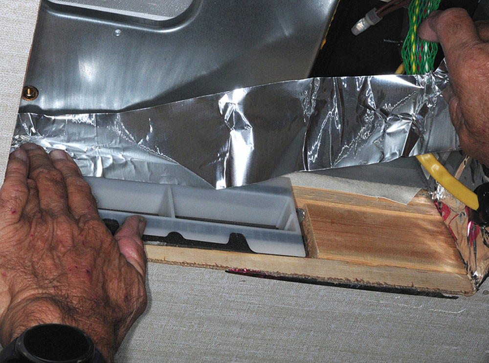 Applying aluminum tape around ducting