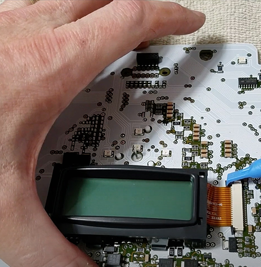 hand working on a programmer board