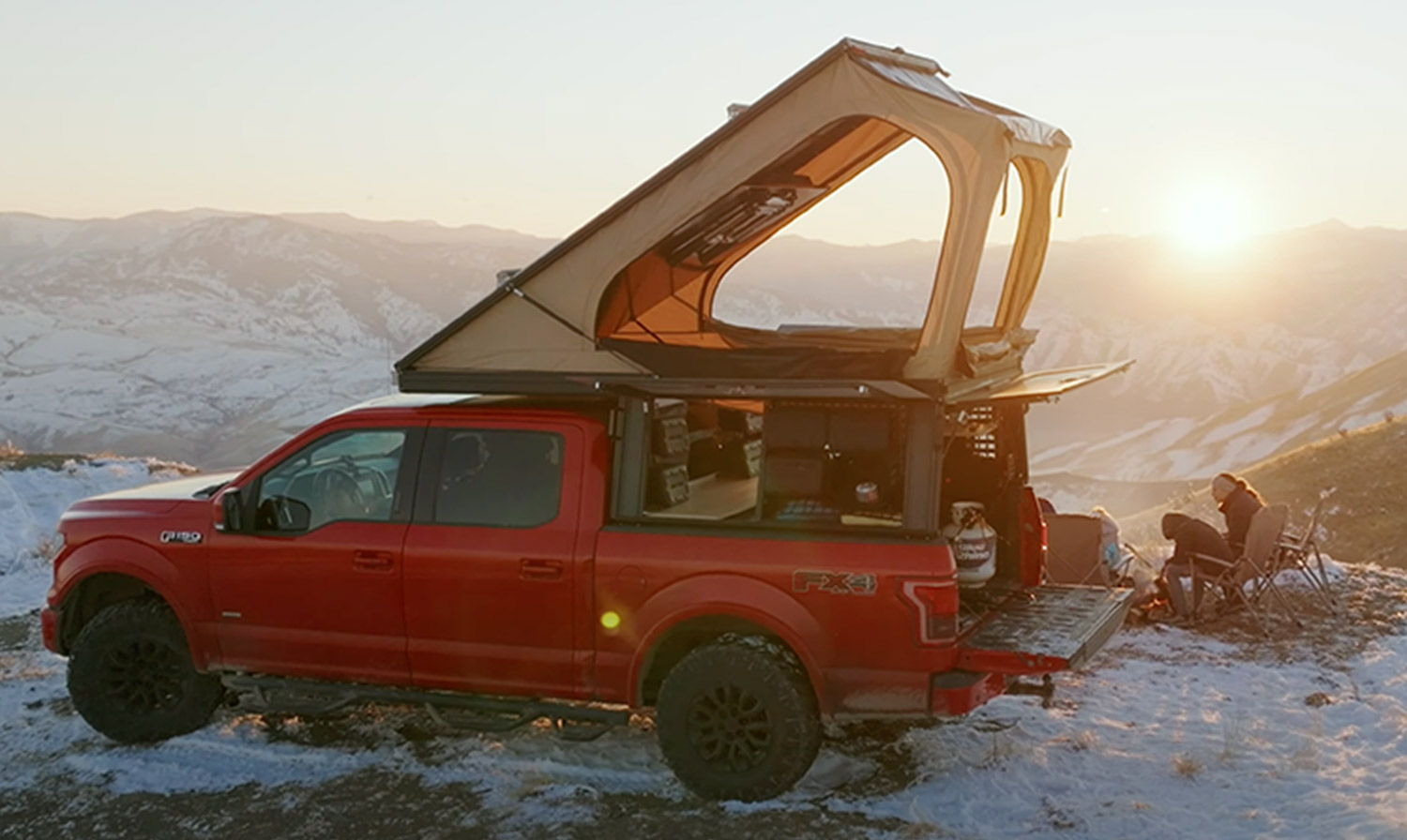 a Lone Peak Camper atop a parked red truck