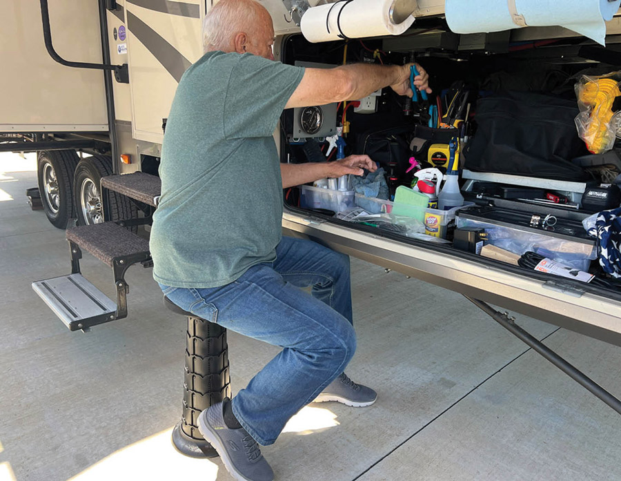man looking at the storage under the RV