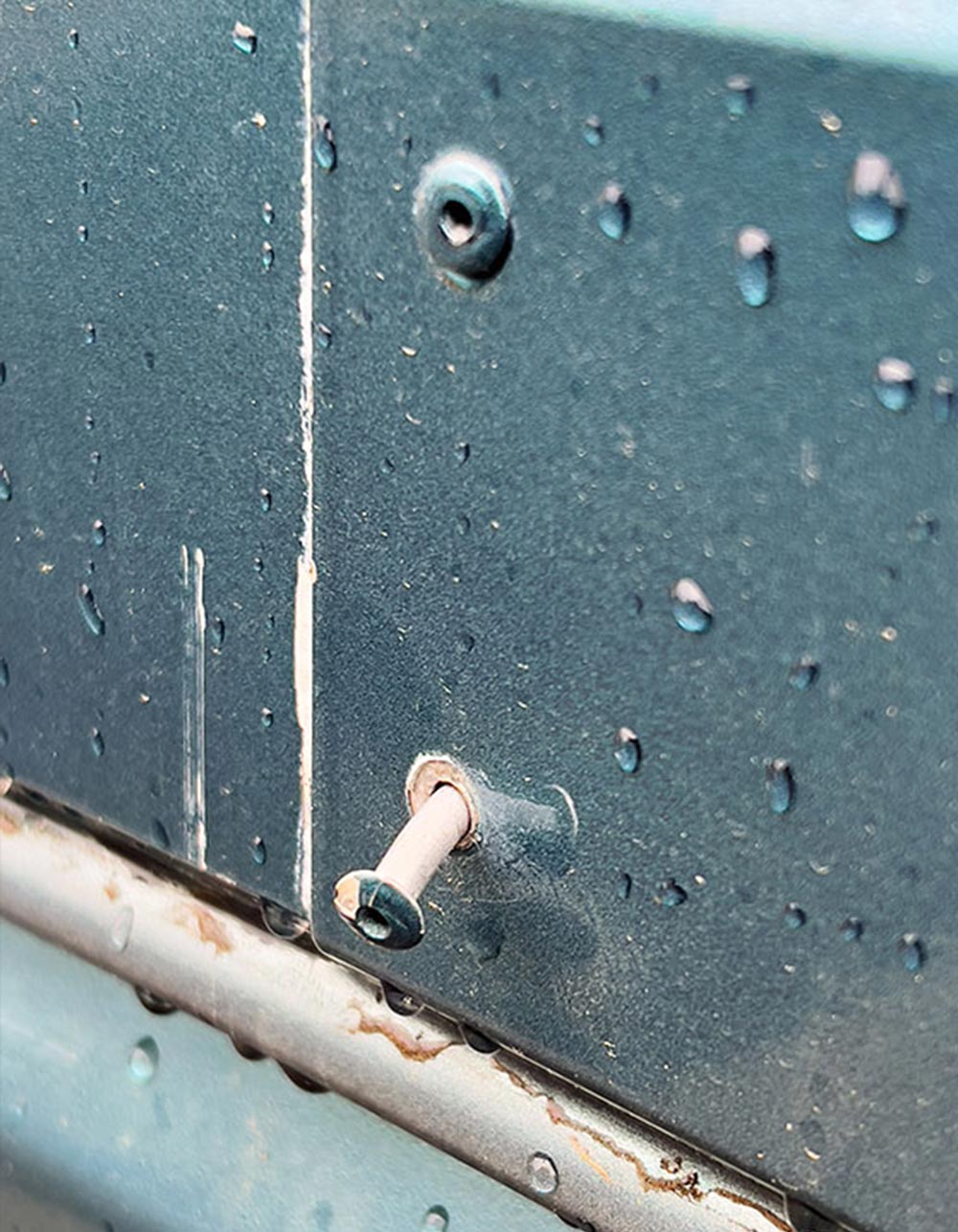 close up of a backed out screw on an RV exterior