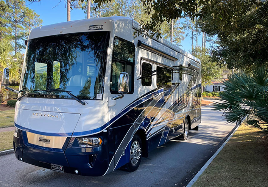 Exterior front side photograph perspective of the 2022 Newmar Ventana Class A in a neighborhood area during the day