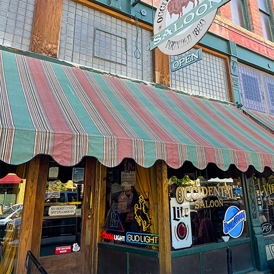 Exterior photograph of Buffalo’s Occidental Hotel building with The Virginian restaurant located inside the building in Buffalo, Wyoming during the day