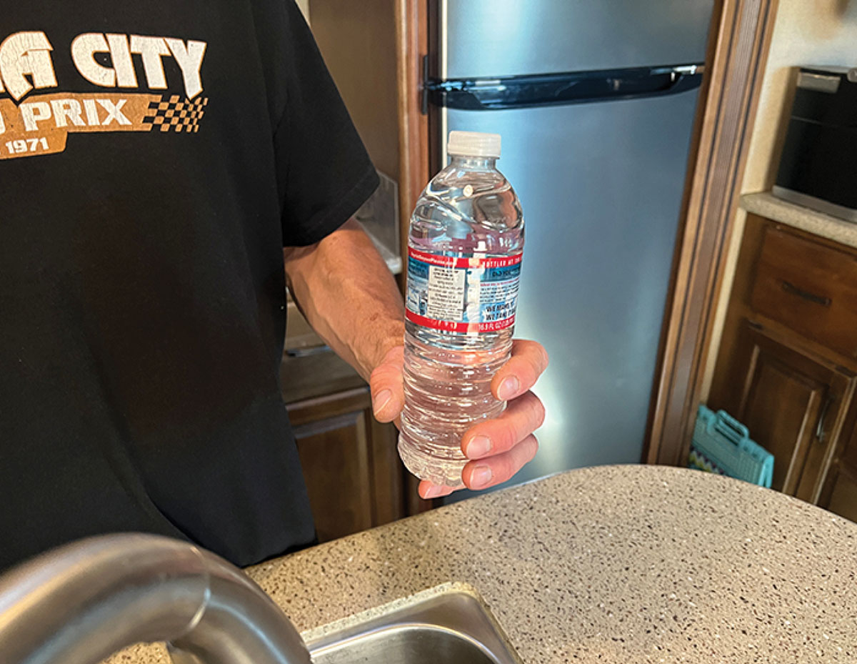 Person holding water bottle