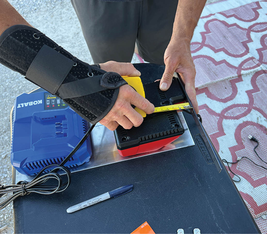 Two slots are provided for each charging base, but the dimensions are different. Measurements were taken to establish positioning; the distance between the center points of the two slots were marked on the housing.