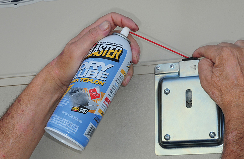 Spraying door latch with Blaster Dry Lube