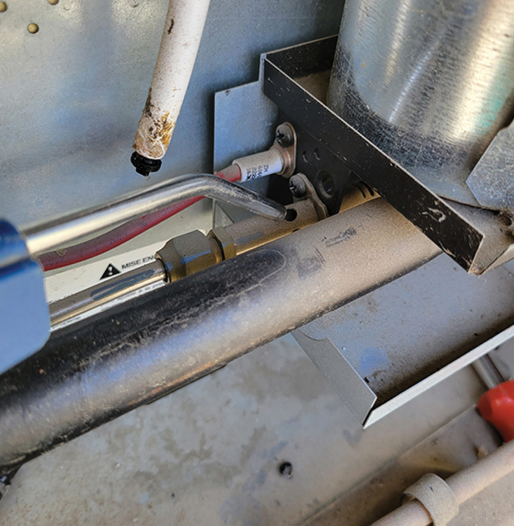 using an air compressor to check the build-up of rust and debris in the absorption refrigerator burner area