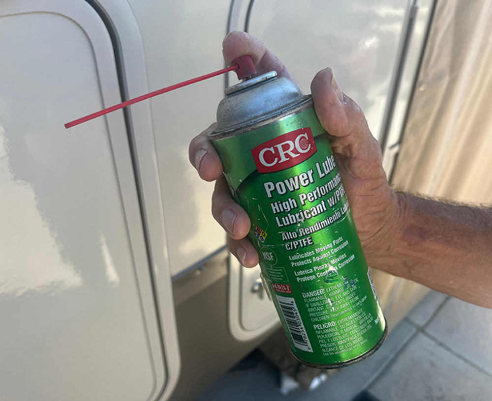 hand holding a can of CRC Power Lube High Performance Lubricant