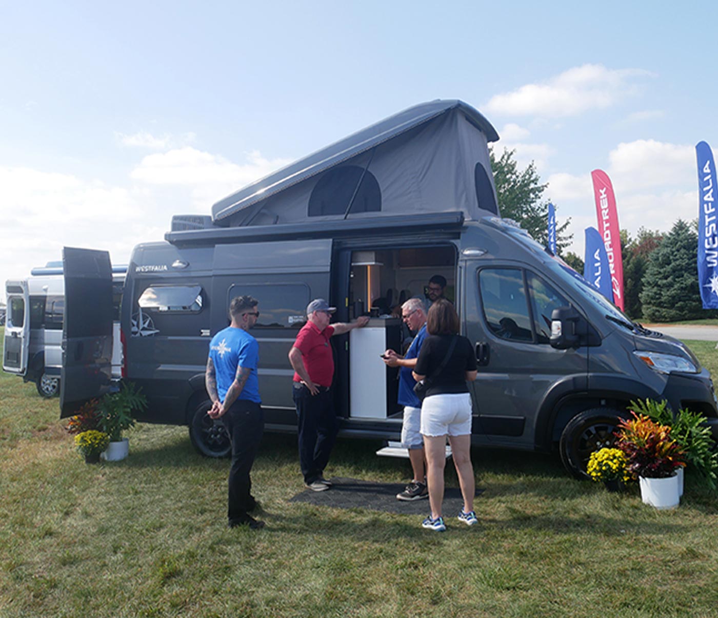 a couple view a Roadtrek Class B Westfalia coach at a dealership