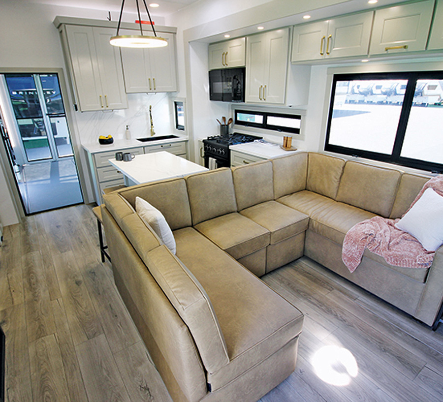 Interior of Brinkley RV Model G 3950 RV with U-shaped couch and kitchen setup 