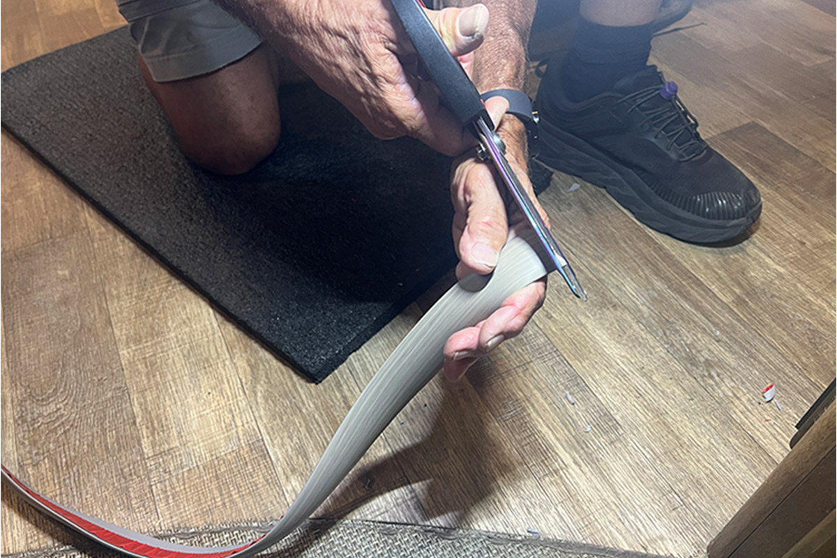 Hands cutting the transition strip