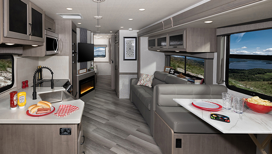 Grey color themed kitchen and living area of RV from REV RV Group