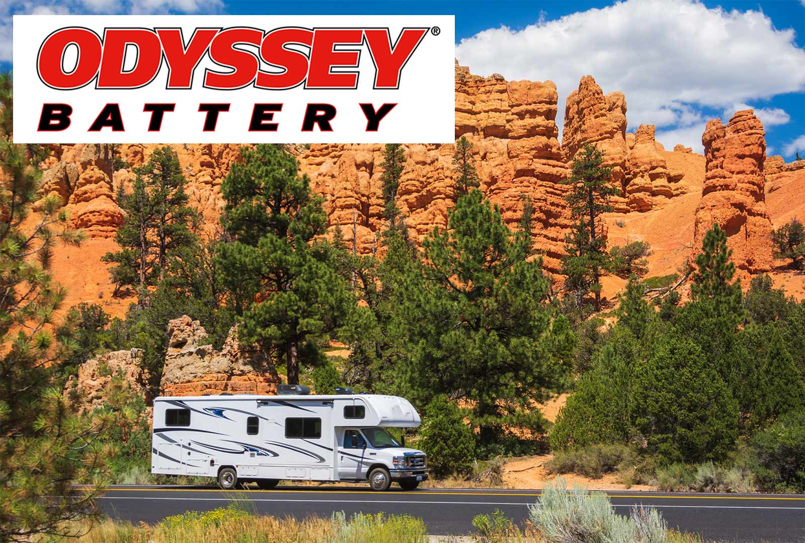 Odyssey Battery, RV on a road in front pine trees and tall red rock cliffs