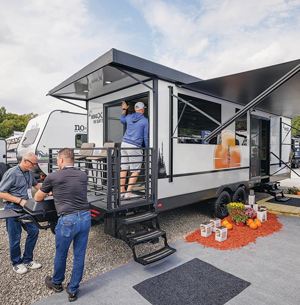 people looking at an RV at an event