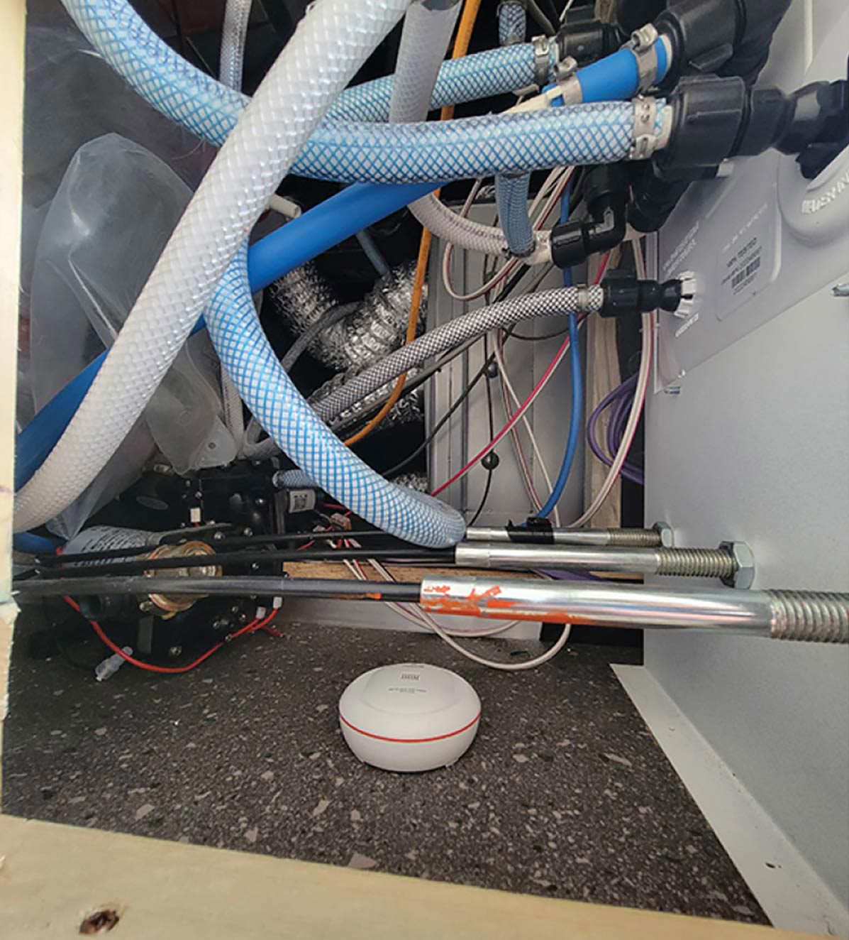 the device is placed on the floor in the vicinity of the water lines and connections
