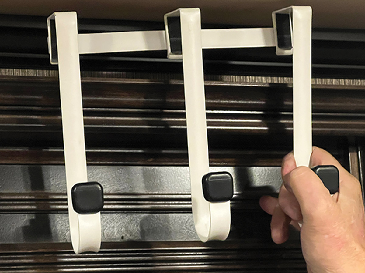 hand holding model of three hooks put together