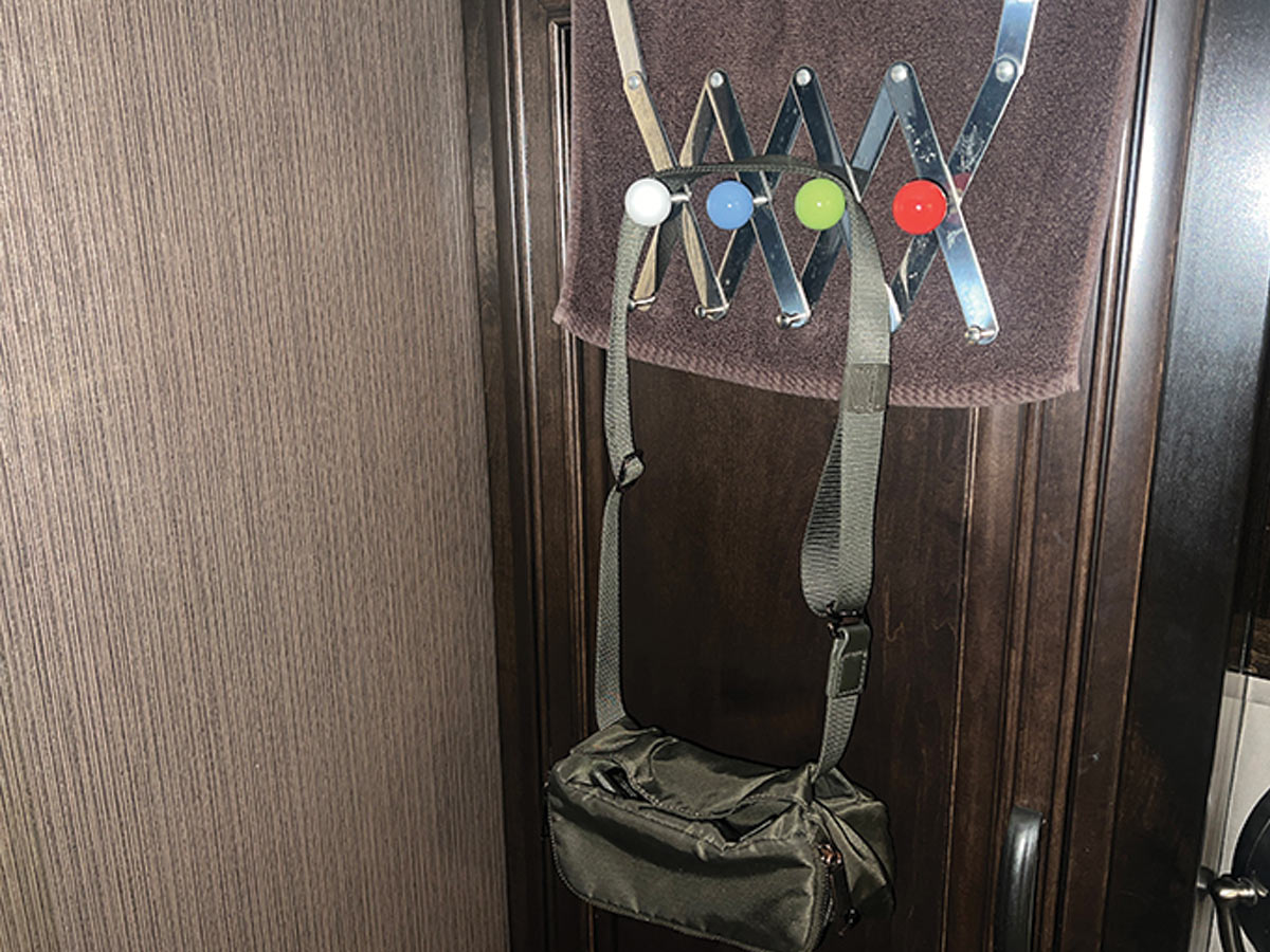 hooks with a white, blue, green, and red design holding a hanging bag