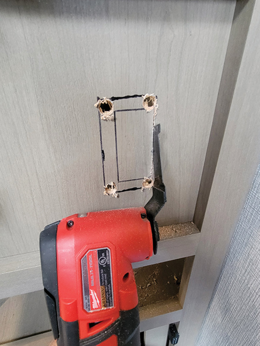 tool cutting a rectangle into wall