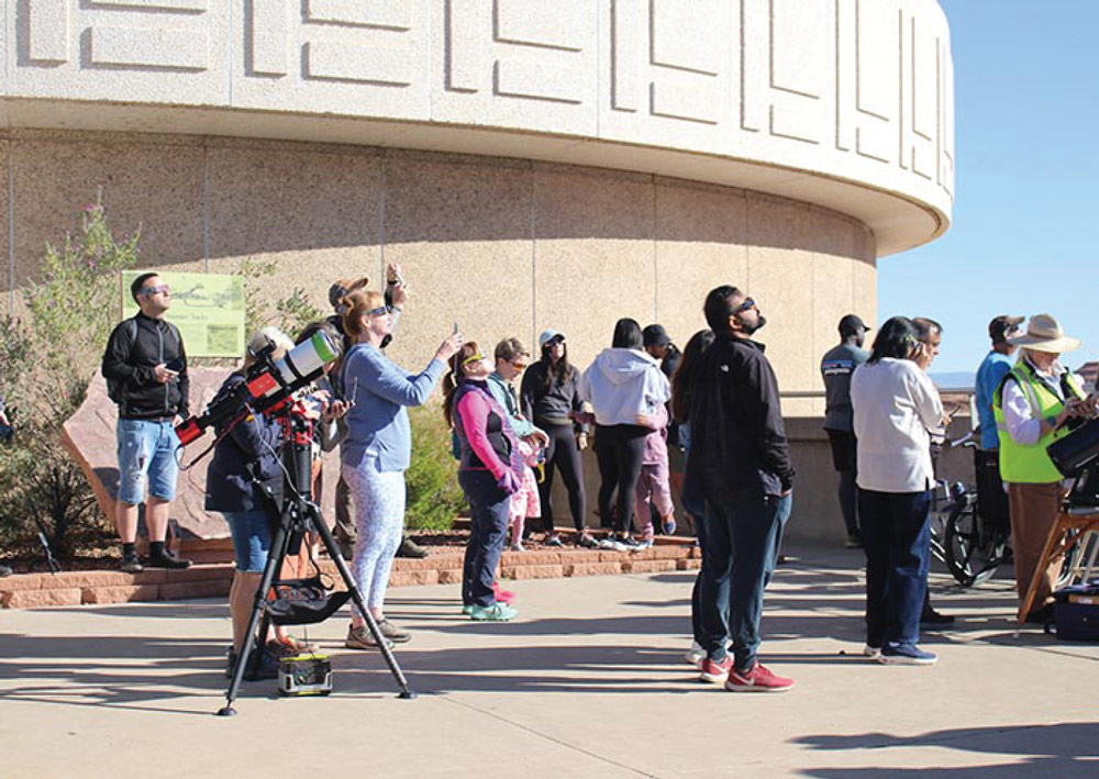 group of people using Solar viewing glasses and scopes