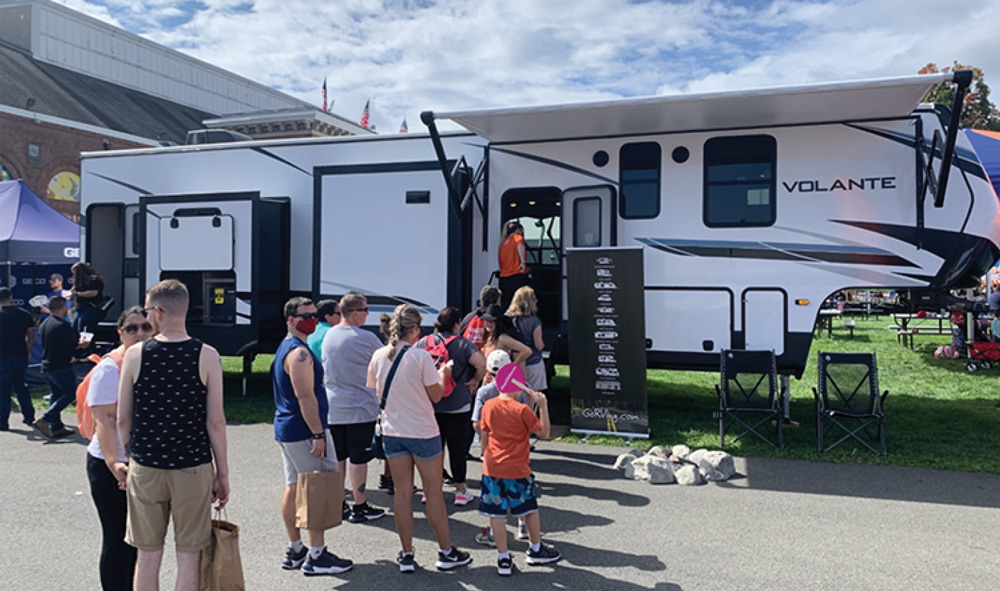 group of people looking at a trailer at an event