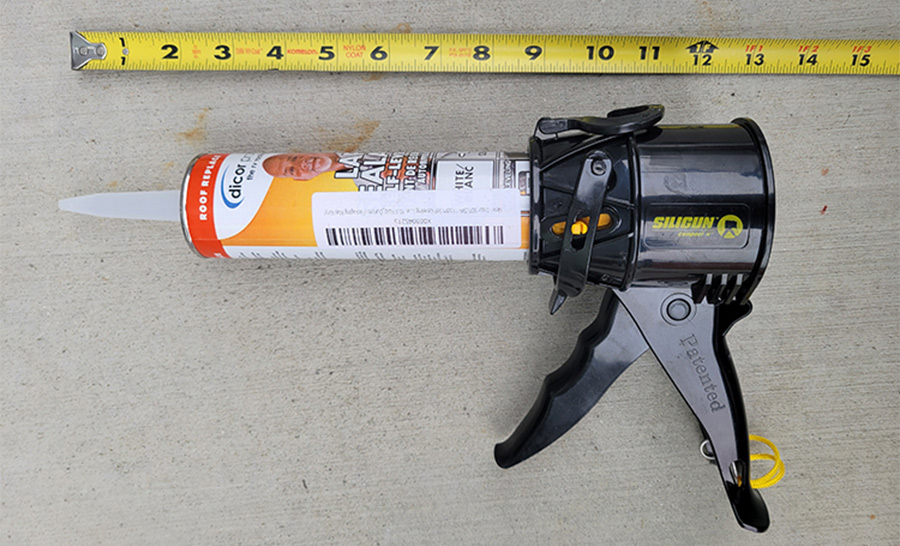 Siligun caulking gun laid out beside a measuring tape