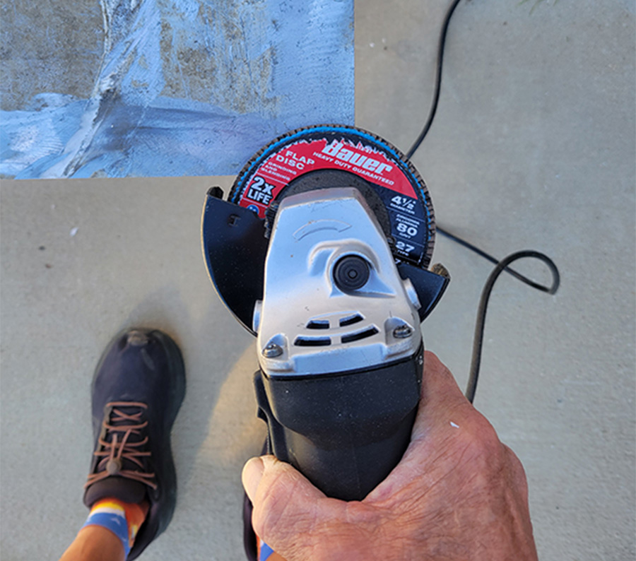 power grinder with a sanding disc being used to clean up the edges of the diamond plate